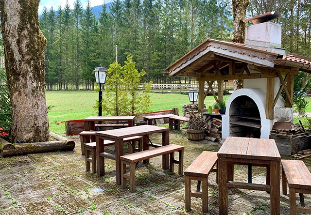 Grillhütte mit Bierbänken im Außenbereich